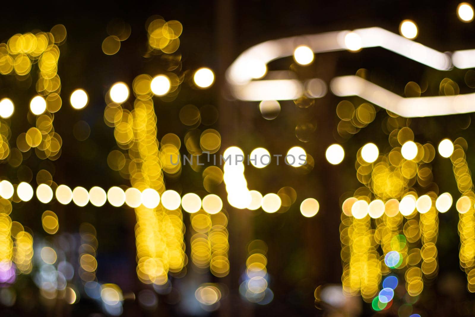 Decorative outdoor string lights hanging on tree in the garden at night time  by piyaphun