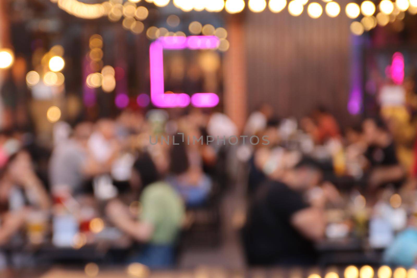 blurred image at the restaurant night time, many people in the restaurant eat and party happy relaxing  by piyaphun