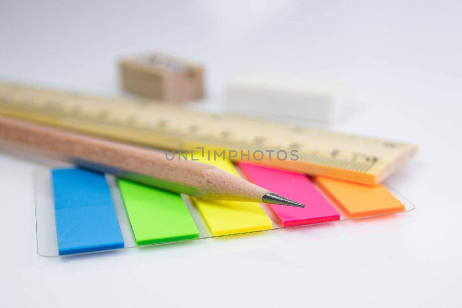 close up a pencil with paper color note on white background by piyaphun