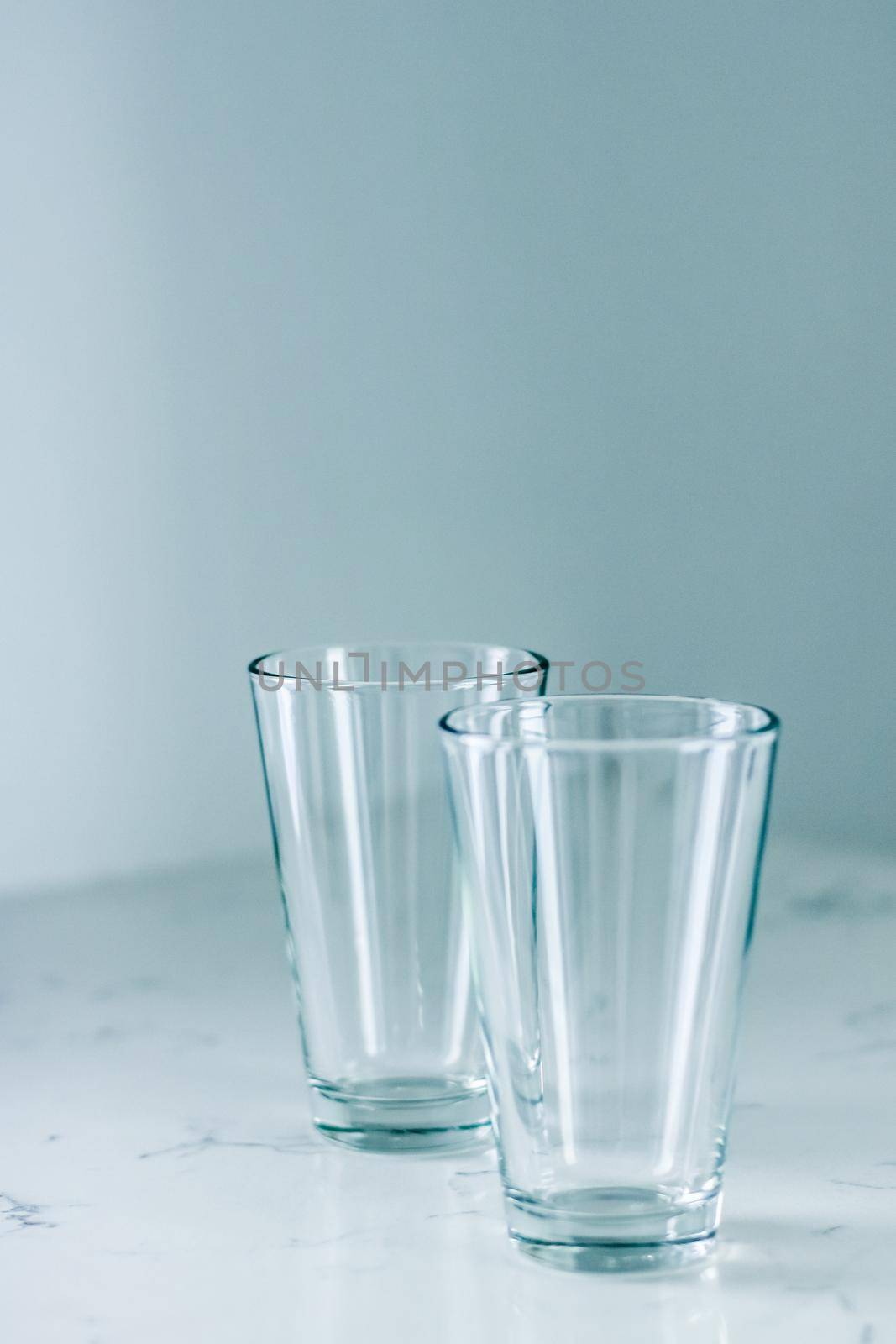 Clean empty glasses on marble table by Anneleven