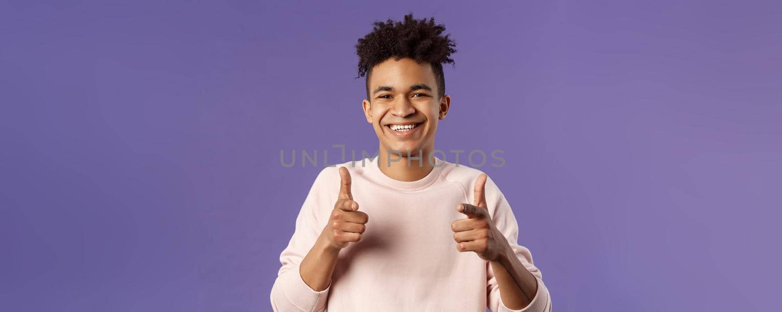 You got it. Close-up portrait of smiling cute young hispanic man saying good luck, pointing fingers at camera with pleased cute grin, encourage person apply for job, headhunter picking new candidates.
