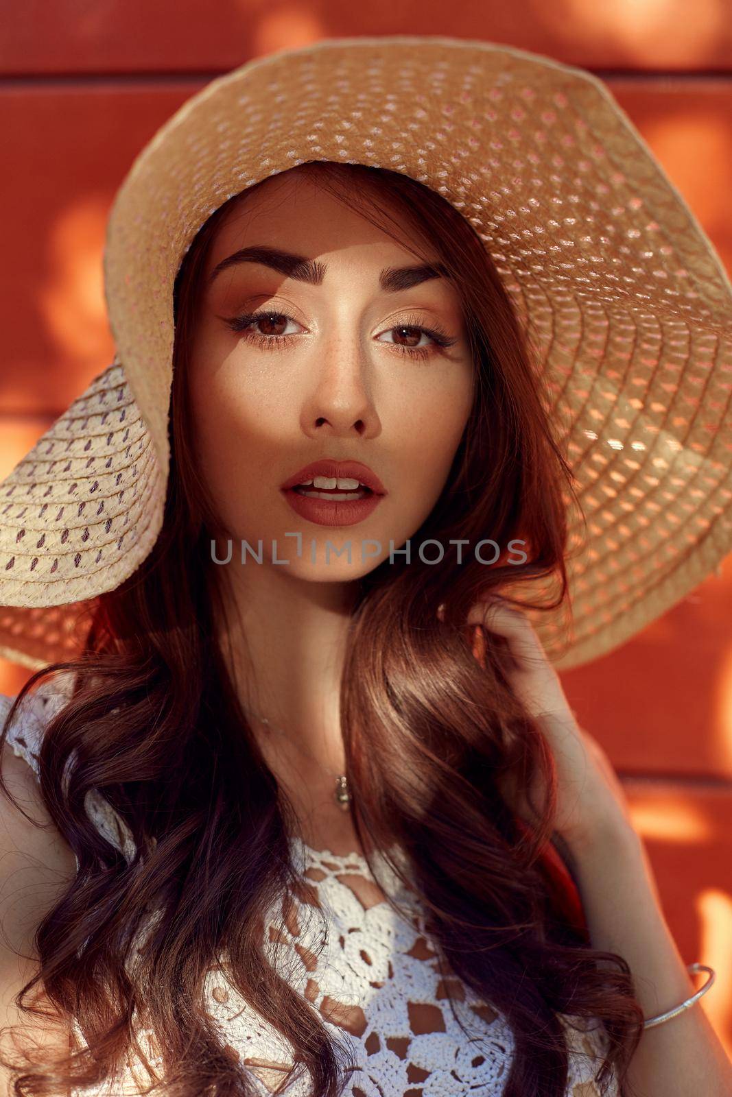 Sunny lifestyle fashion portrait of young stylish hipster woman walking on the street, wearing trendy outfit, straw hat, travel.