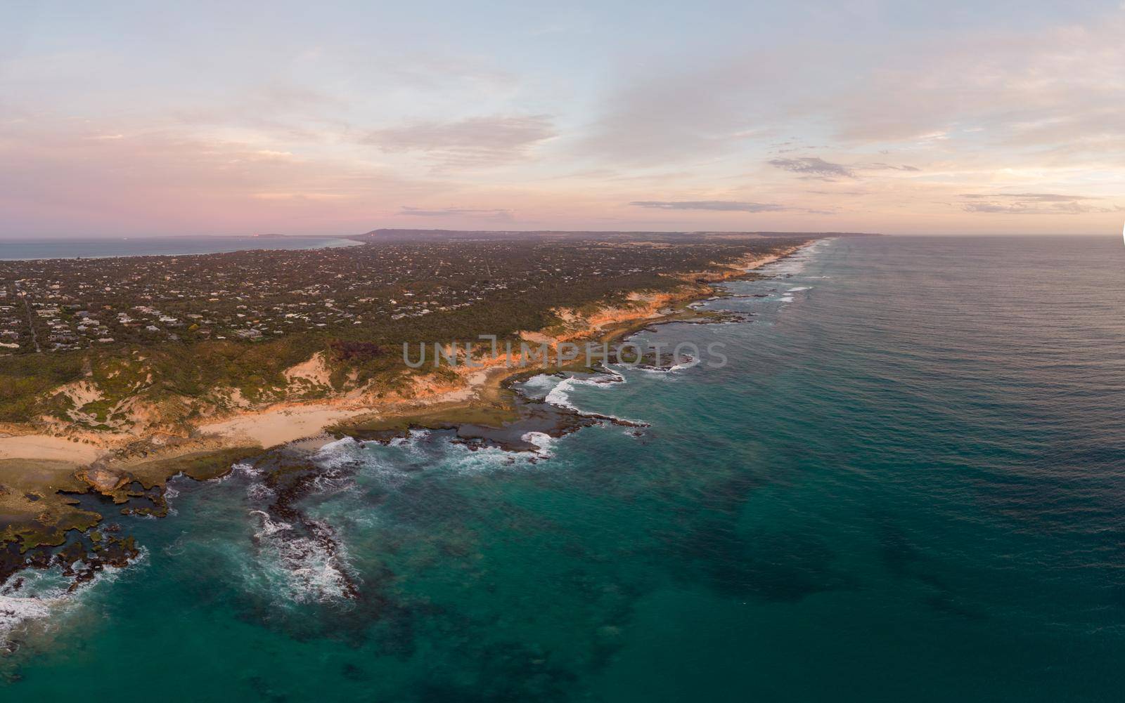 An aerial shot of Mornington Peninsula towards Point Nepean and Port Phillip Bay at sunset in Victoria, Australia