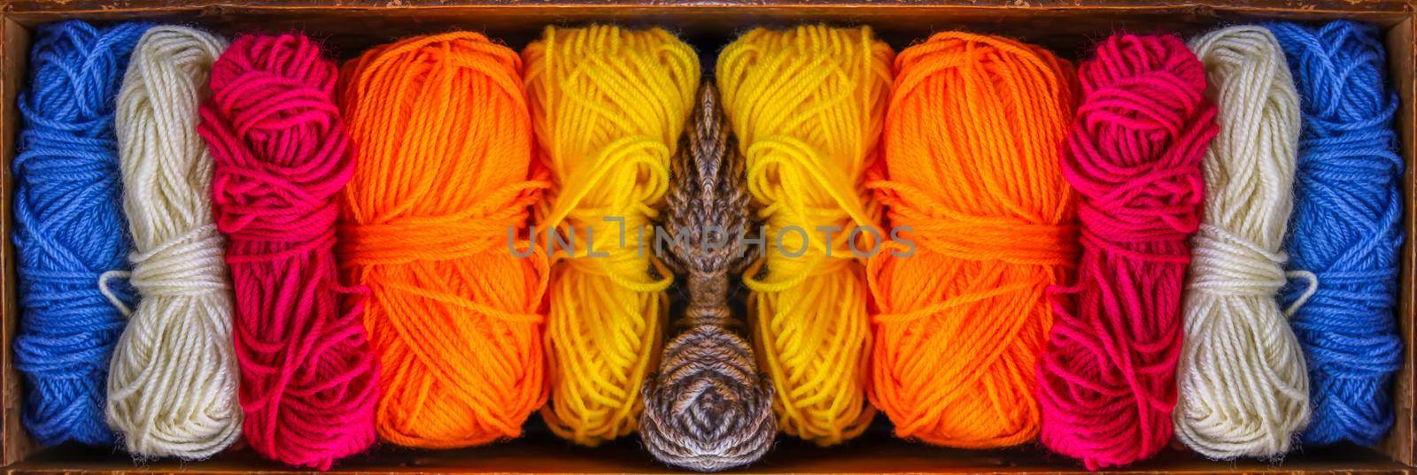 Colorful skeins of yarn in old wooden vintage box close up. by nightlyviolet