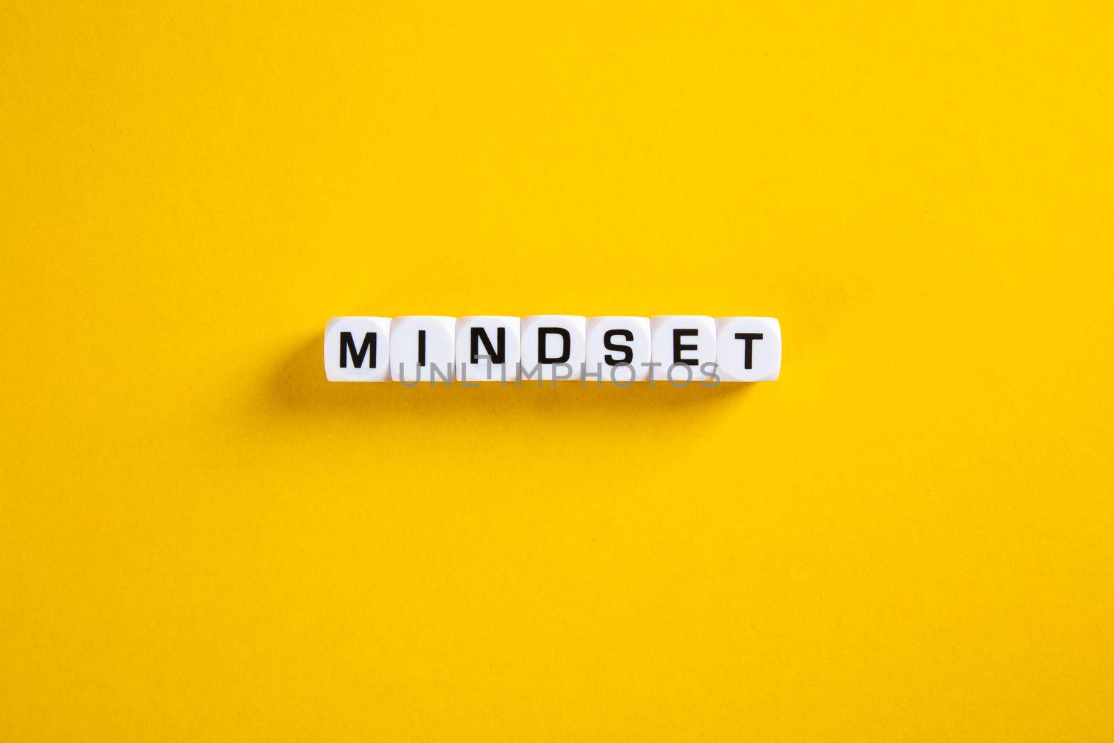 Mindset word on yellow background. by tehcheesiong