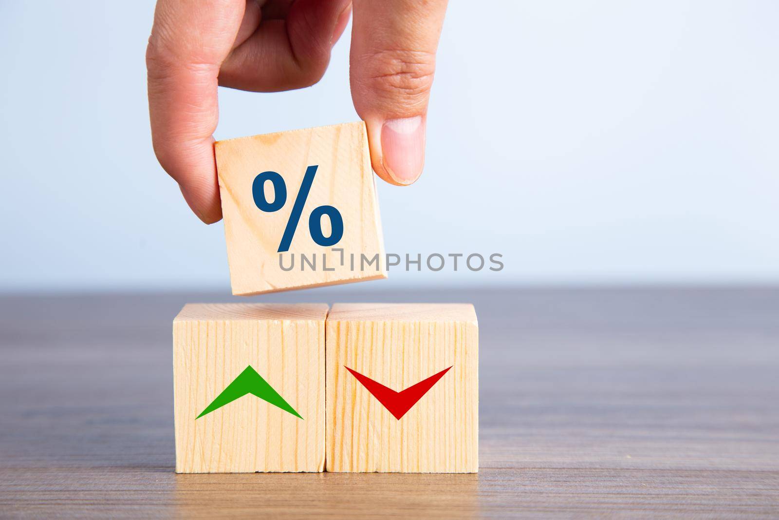 Wooden blocks with percentage sign and arrow, financial growth concept