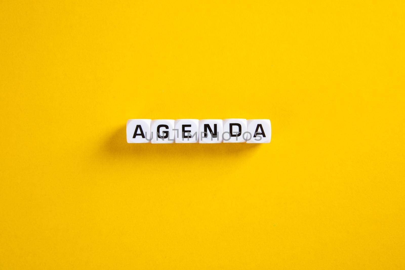 Block with Agenda word on yellow background
