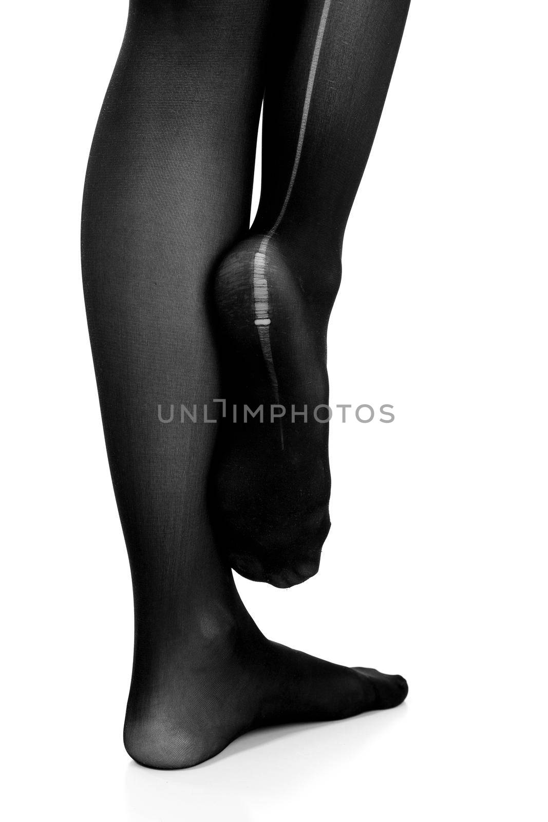 Woman's legs in torn pantyhose, isolated on white background