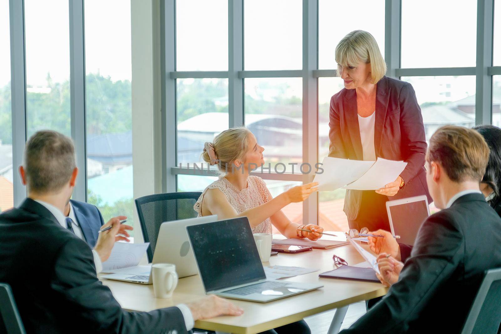 Manager woman or leader of business teams discuss with detail in the document with her workers and they look relax and happy during meeting time.