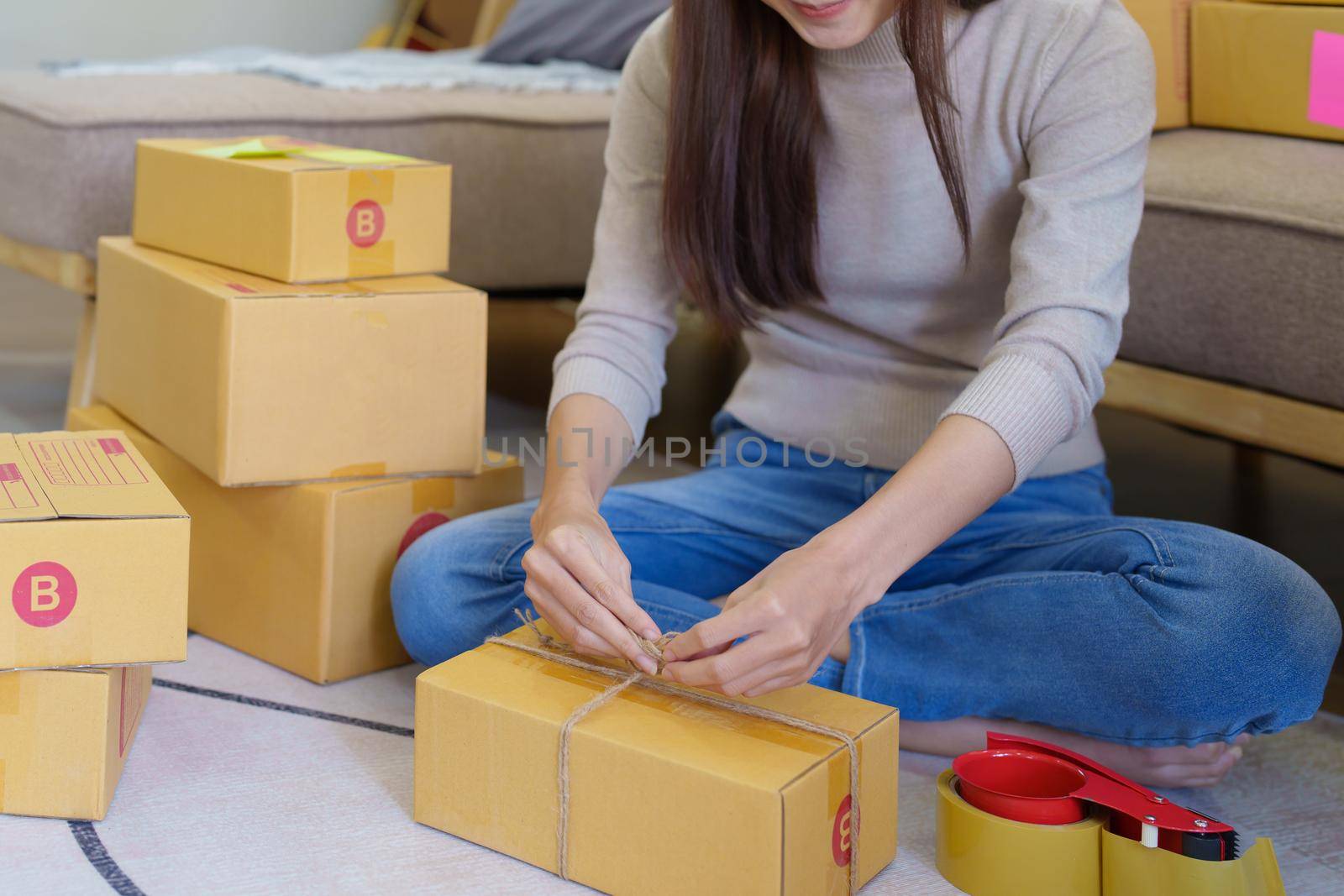 Starting small businesses, Asian woman check online orders Selling products working with boxs freelance work at home office, sme business concepts