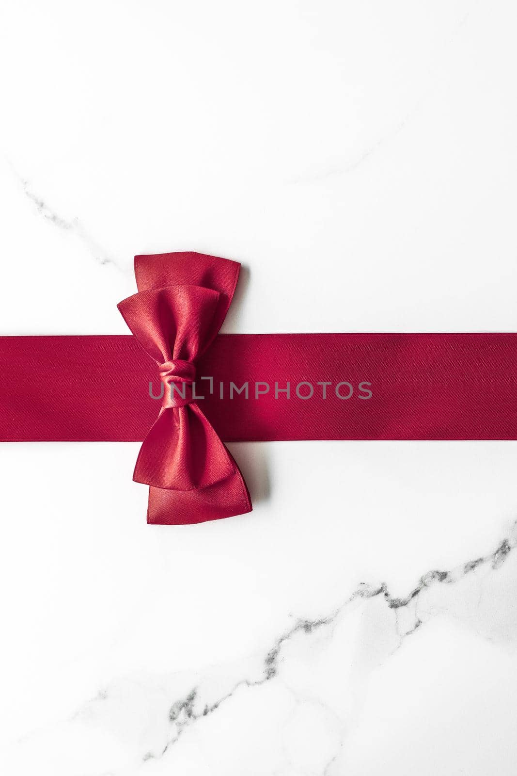 Bordeaux silk ribbon on marble background, flatlay by Anneleven