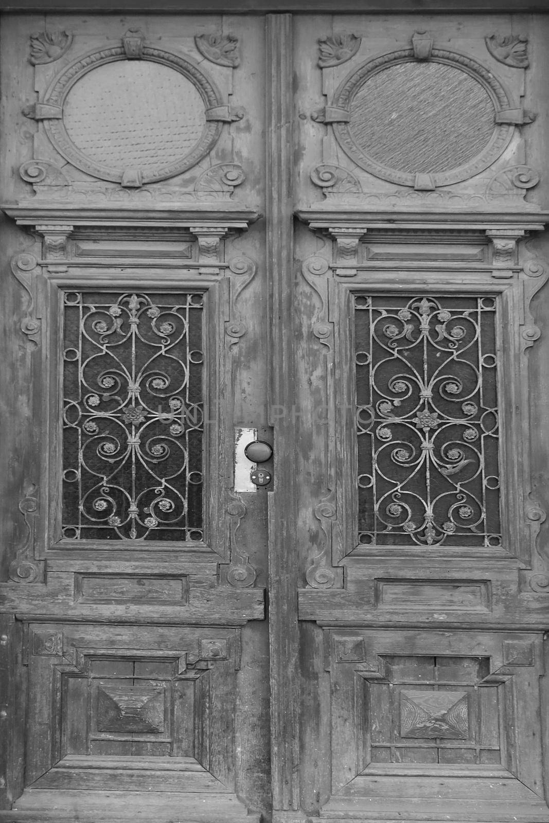 Black and white photo. Old wooden entrance doors