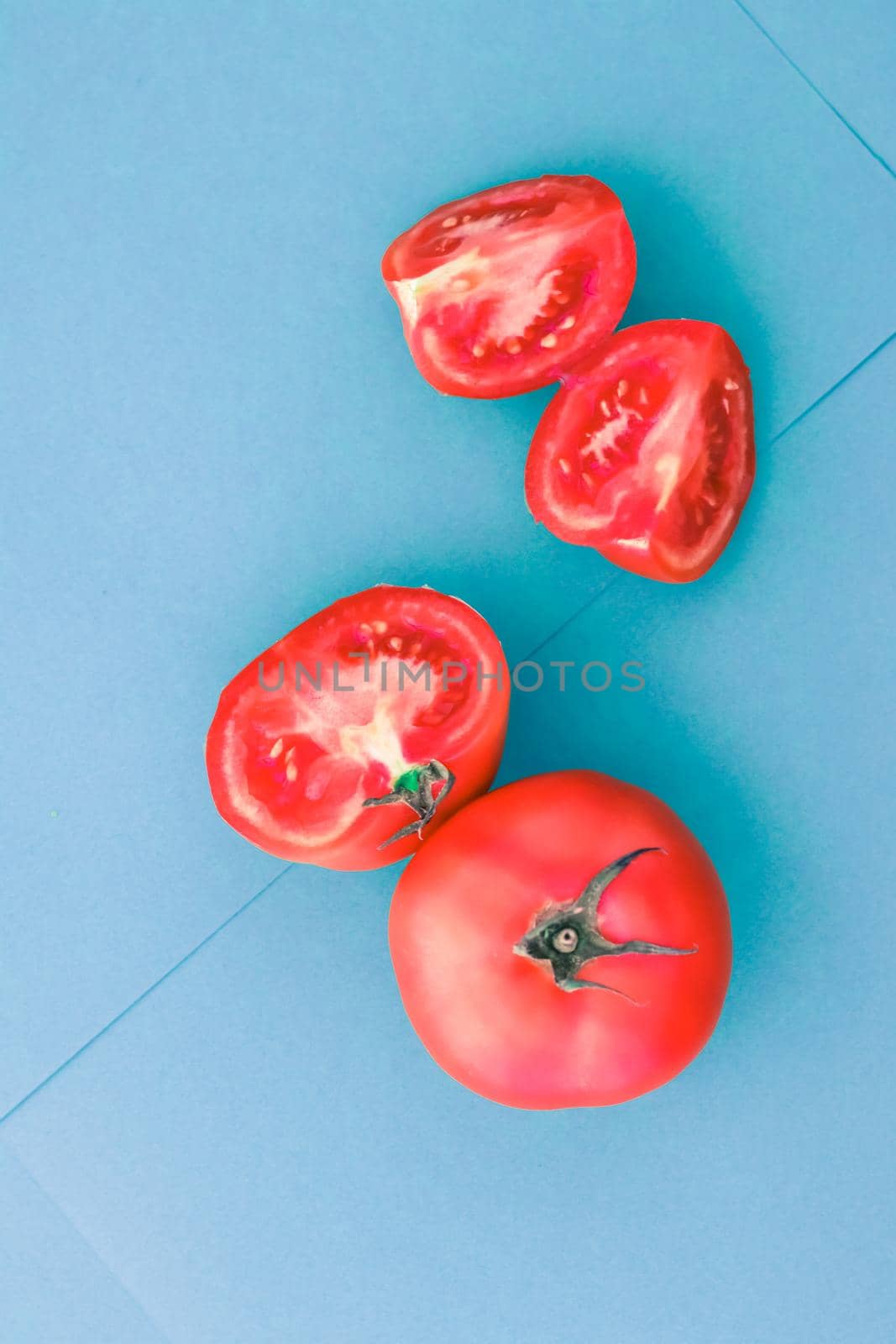 Fresh ripe red tomatoes on blue background, organic vegetable food by Anneleven