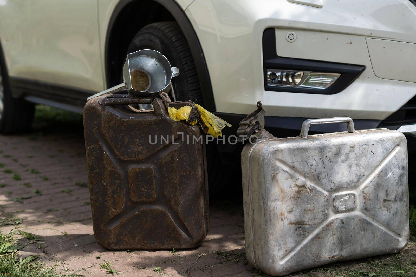 canister and watering can for diesel. the canister with the fuel and the filler funnel