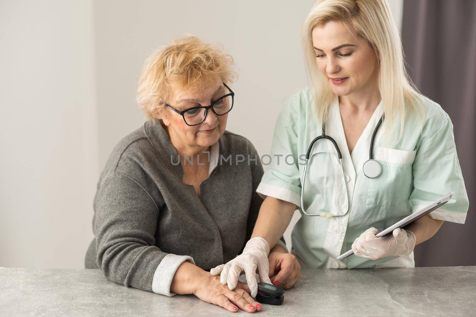 doctor talk with old female patient about disease symptom, doctor use fingertip pulse oximeter with old patient, elderly health check up and health screening, medical technology.