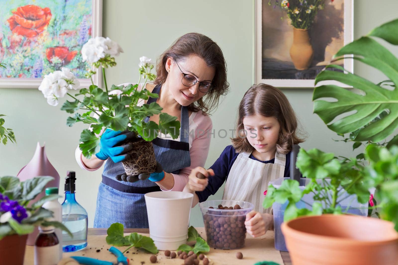 Mother and daughter child plant potted plants, flowers. Hobbies and leisure, care, family, houseplant, home potted friends concept