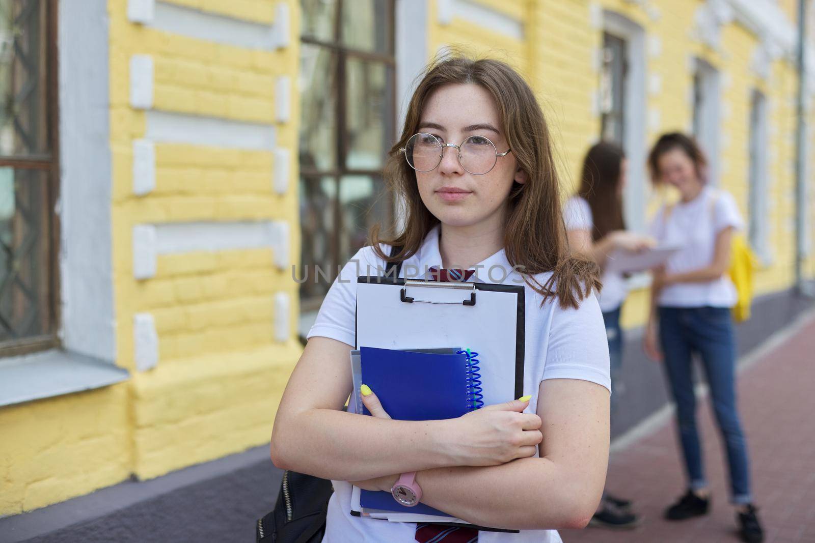 Portrait girl student teenager in glasses tie white T-shirt with backpack by VH-studio