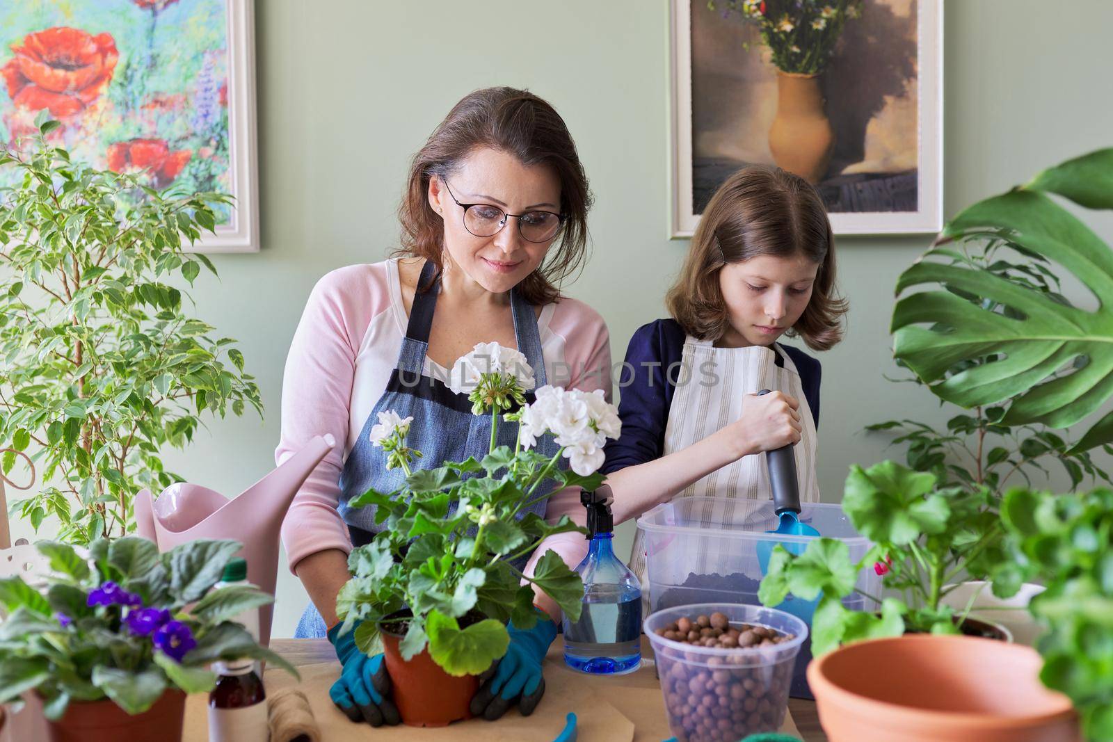 Mother and daughter child plant potted plants, flowers. Hobbies and leisure, care, family, houseplant, home potted friends concept