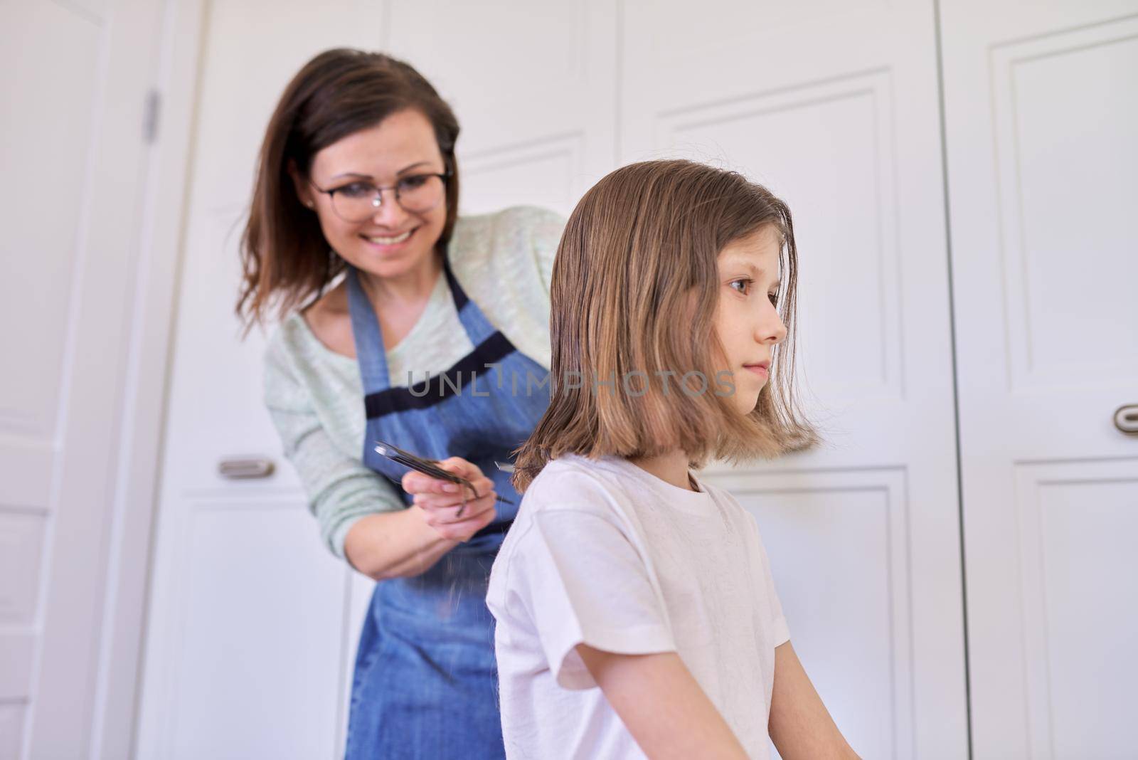 Mother cutting hair to daughter at home, children, hairstyles, hair, beauty.
