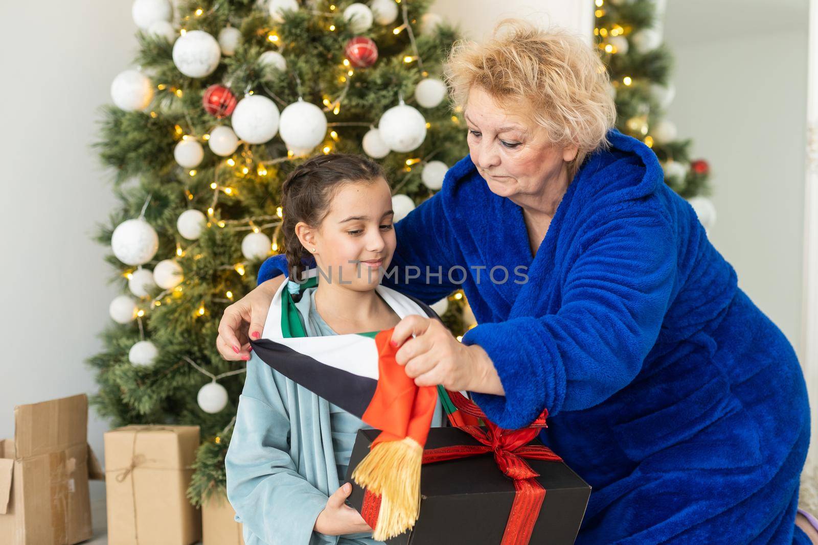 grandmother and granddaughter christmas with flag of united arab emirates at christmas.