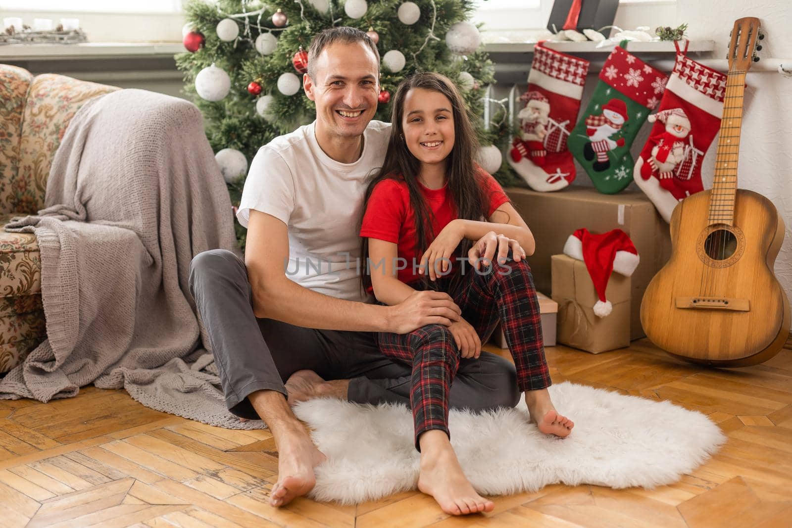family, christmas, x-mas, happiness and people concept - smiling father and daughter