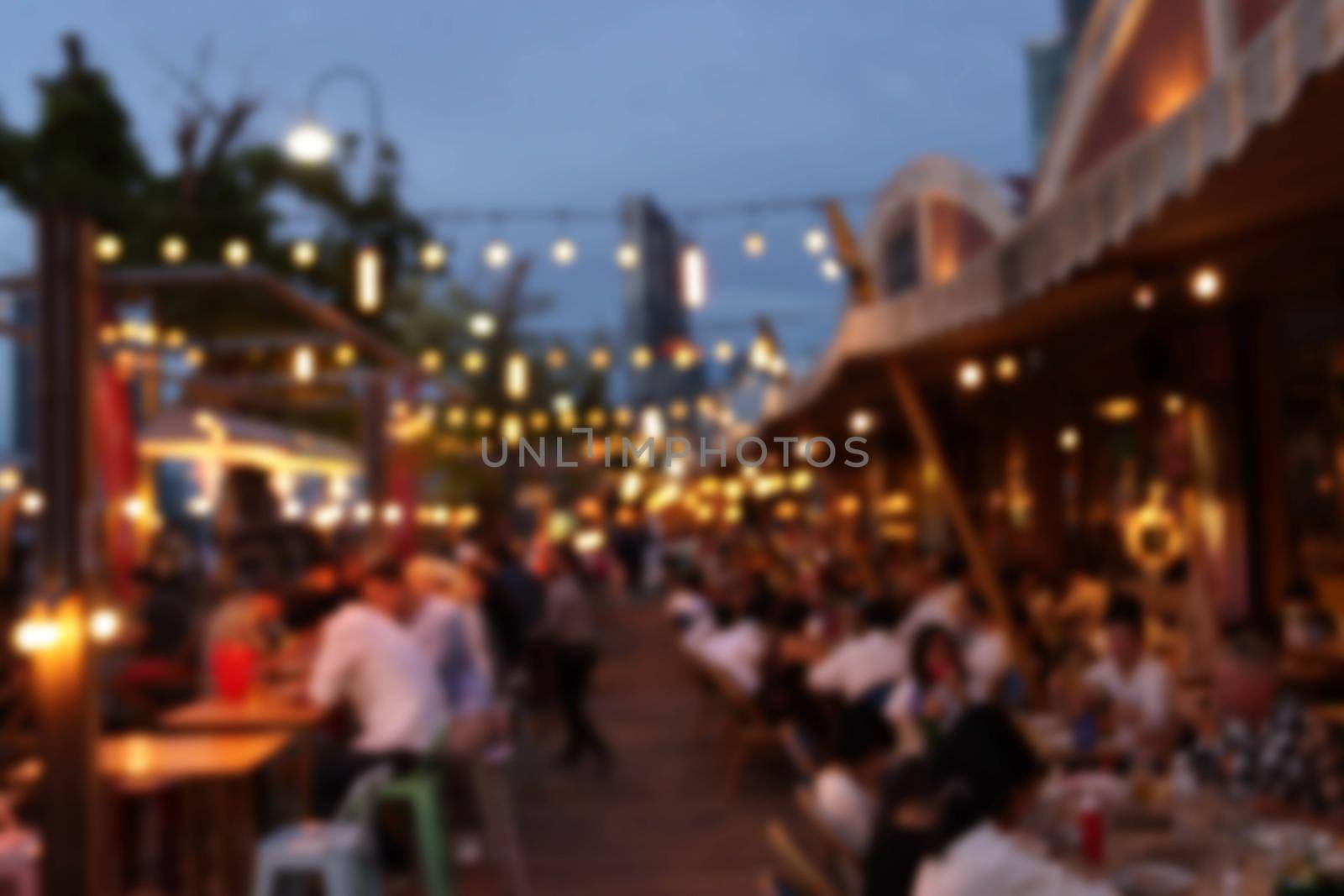 blurred image at the restaurant night time, many people in the restaurant eat and party happy relaxing  by piyaphun