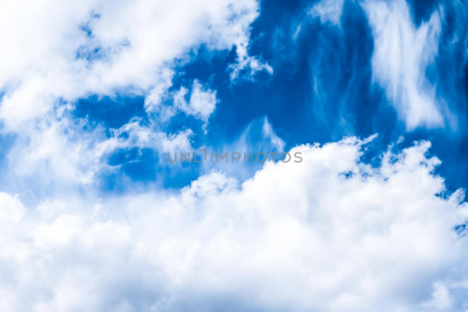 Nature backdrop, solar energy and spiritual concept - Blue sky background, white clouds and bright sunlight