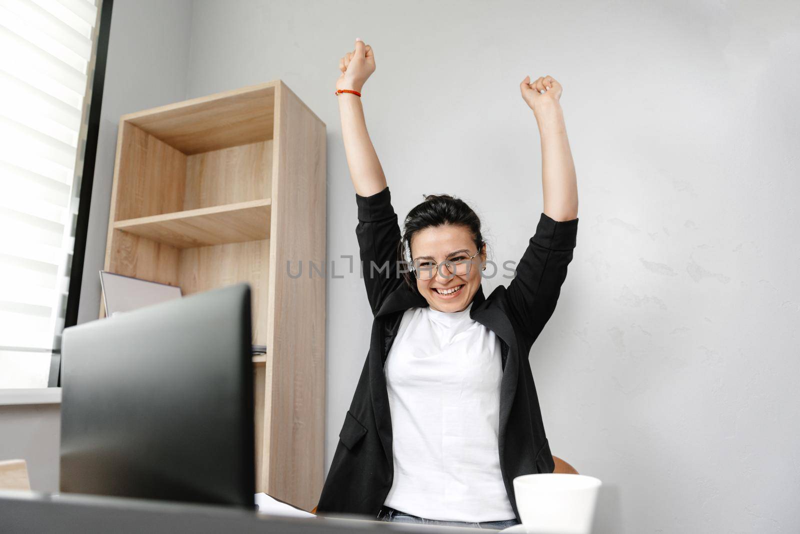 Smiling female freelancer using laptop, researching online, working from home, happy casual millennial guy typing on laptop PC, browsing the internet, looking at screen, enjoying remote work, sitting at desk.