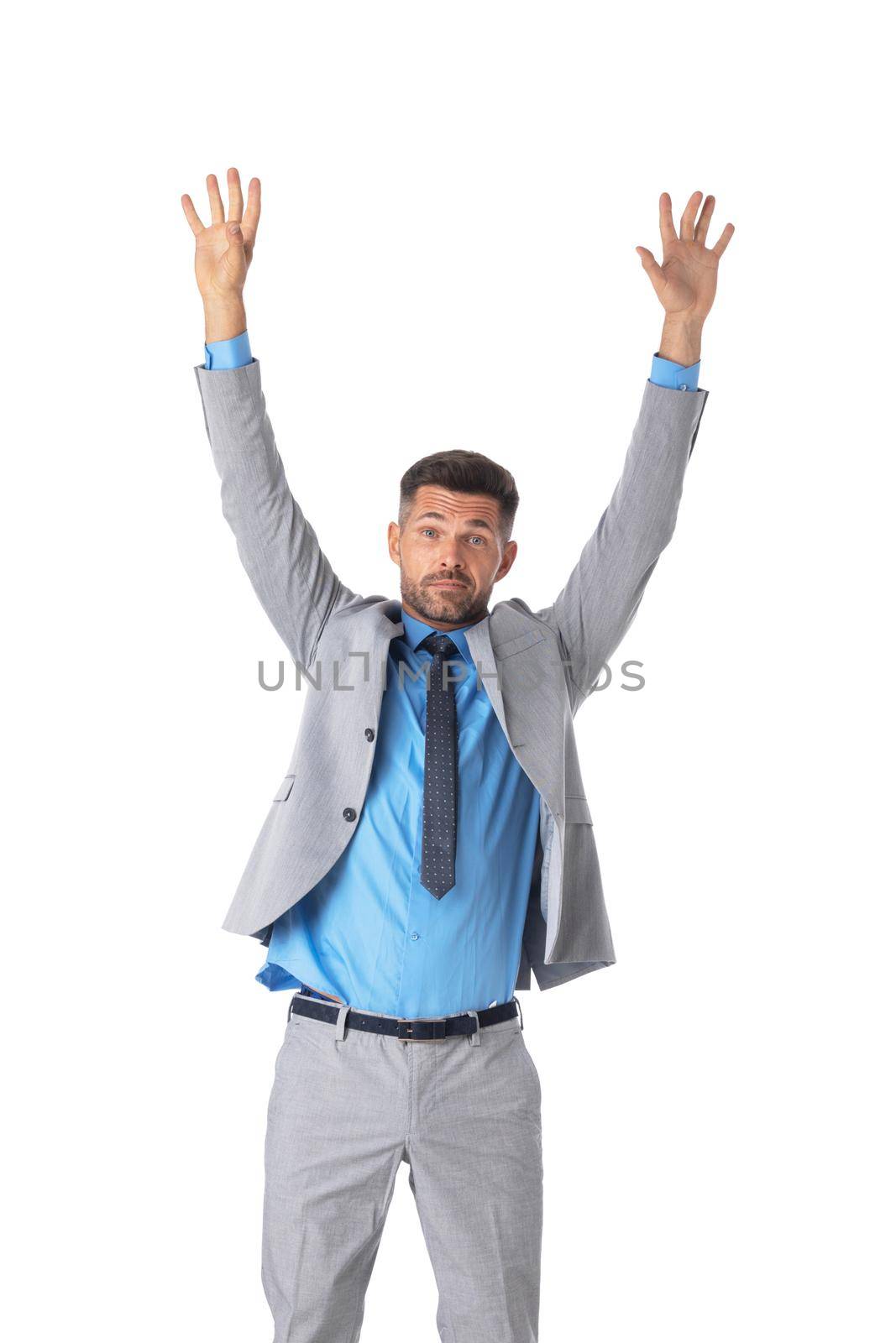 Portrait of young handsome business man in gray suit with raised arms up studio isolated on white background