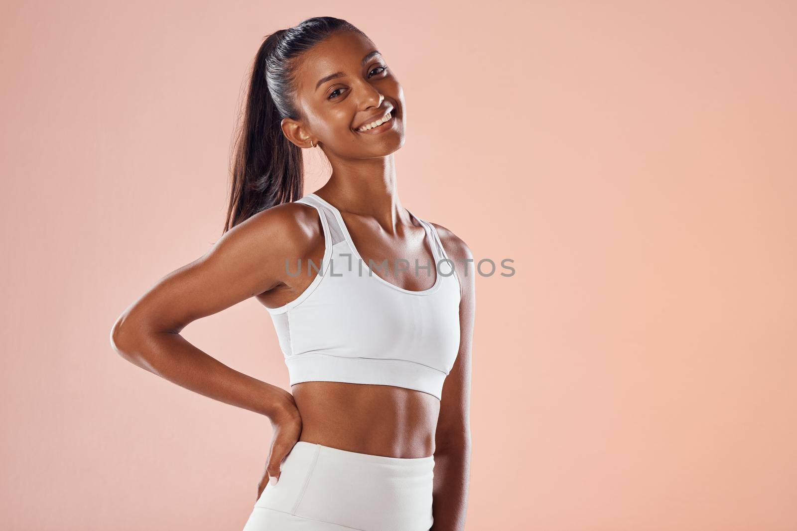 Fit, athletic and stylish female athlete in sportswear smiling and feeling happy, ready and excited for a workout. Portrait of a cute African American athlete with an active style by YuriArcurs