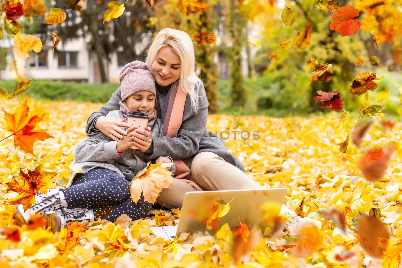 Happy family on autumn walk Mother and daughter walking in the Park and enjoying the beautiful autumn nature. by Andelov13