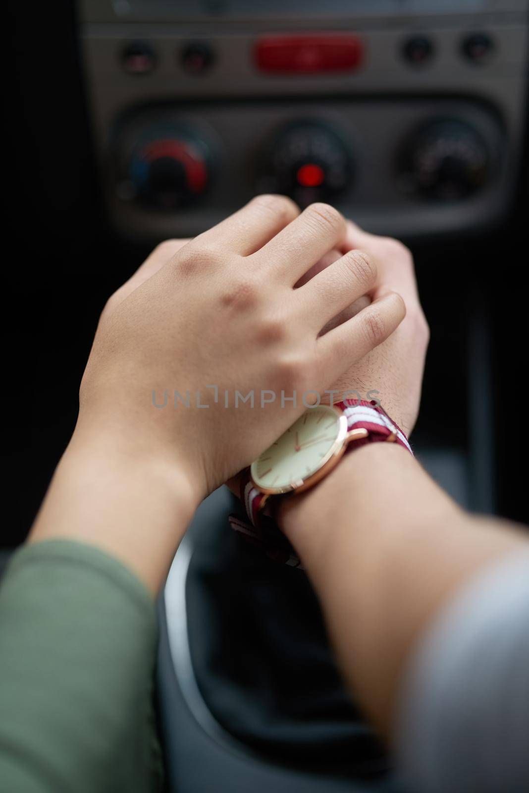 Life is a journey. Closeup shot of a couple holding hands while driving in a car. by YuriArcurs