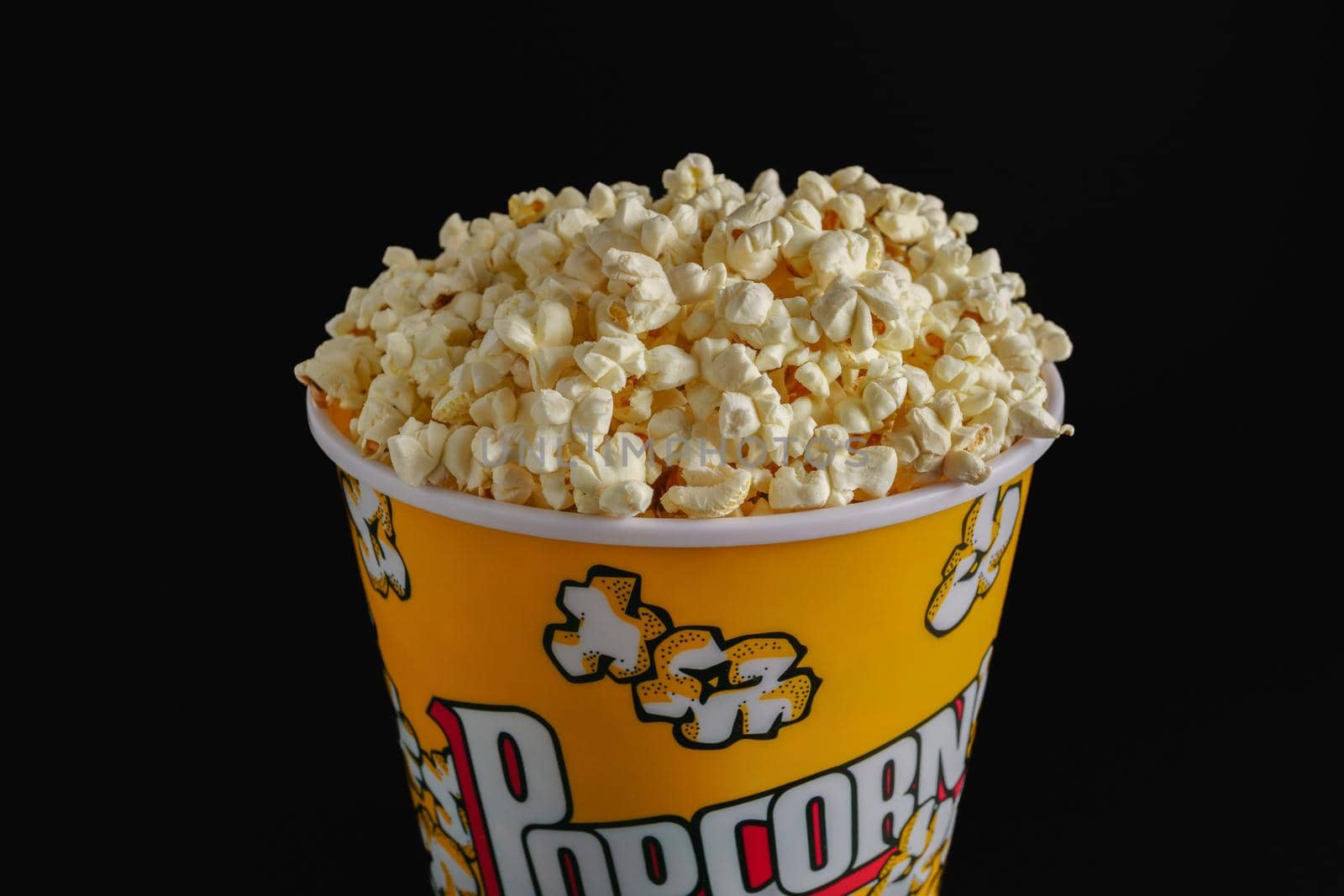 close-up of a popcorn jar with black background by joseantona