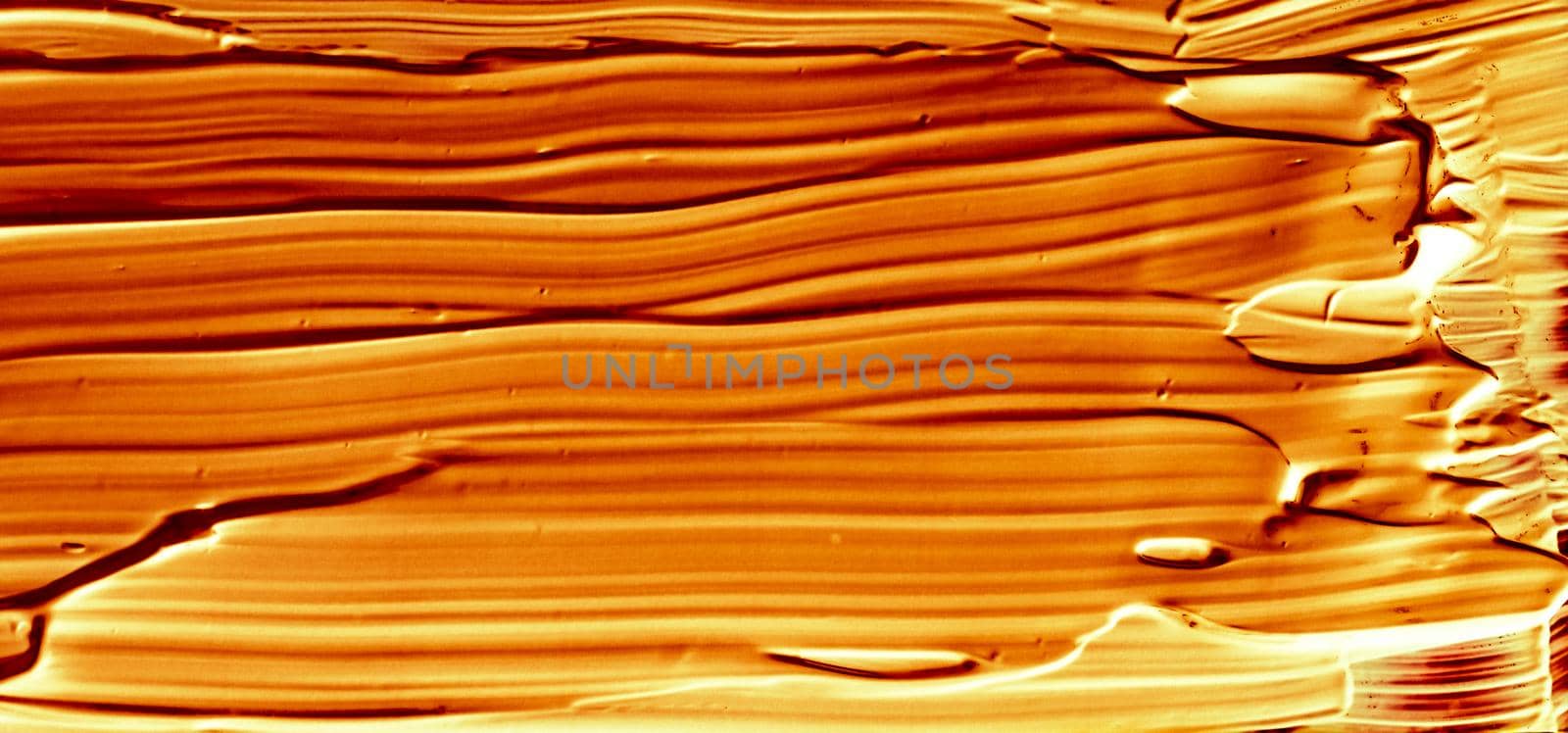 Art abstract, cosmetic product and hand painted design concept - Golden paint brush stroke texture isolated on black background