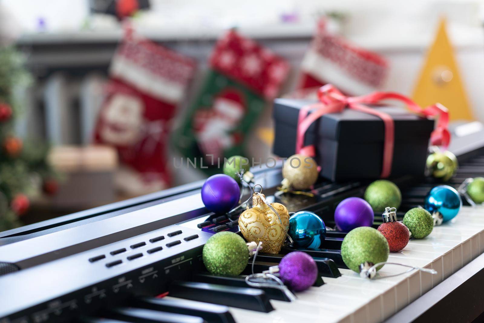 Piano keyboard with Christmas decoration, closeup by Andelov13