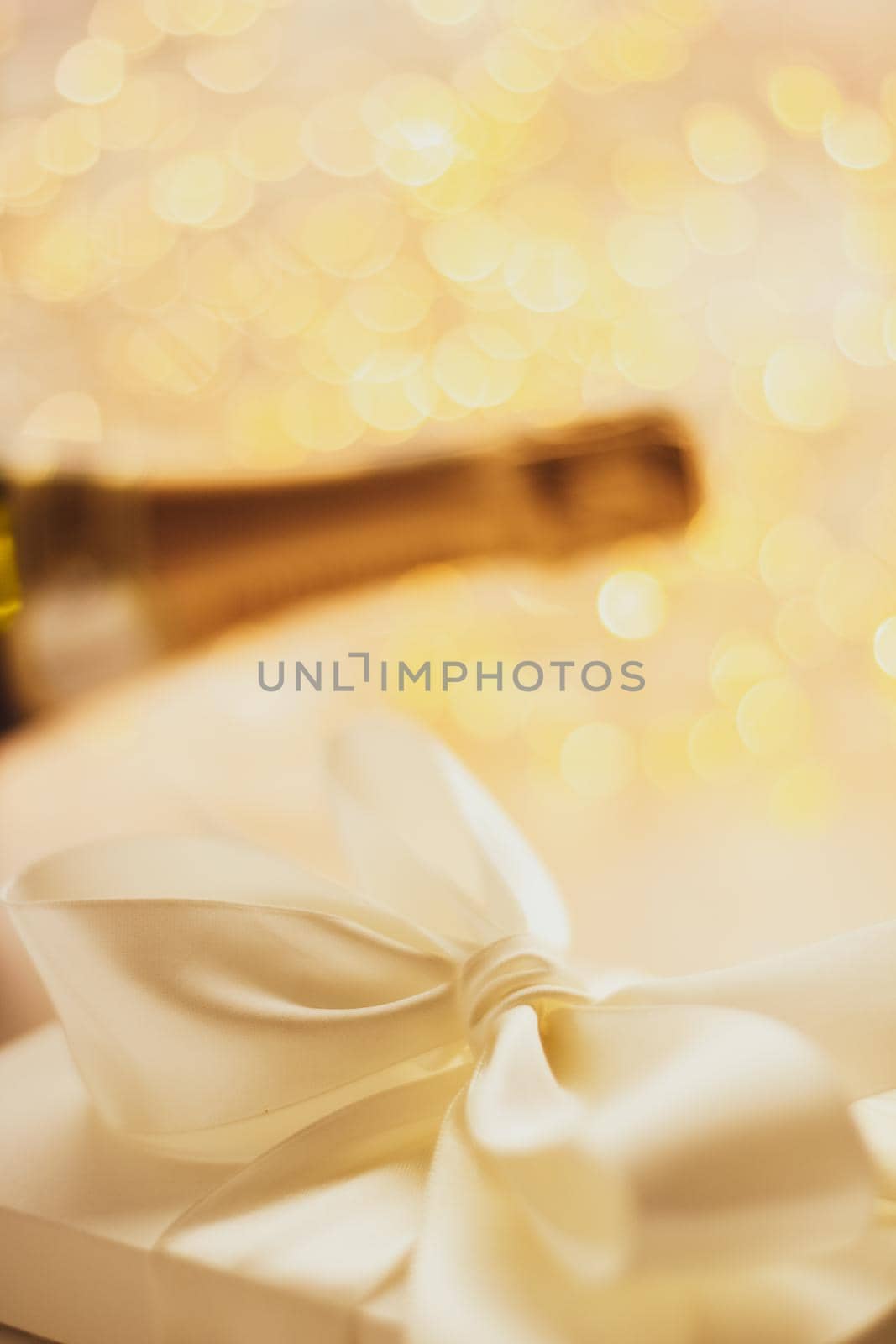 Romantic celebration, lifestyle and luxury present concept - The bottle of champagne and holiday gift box