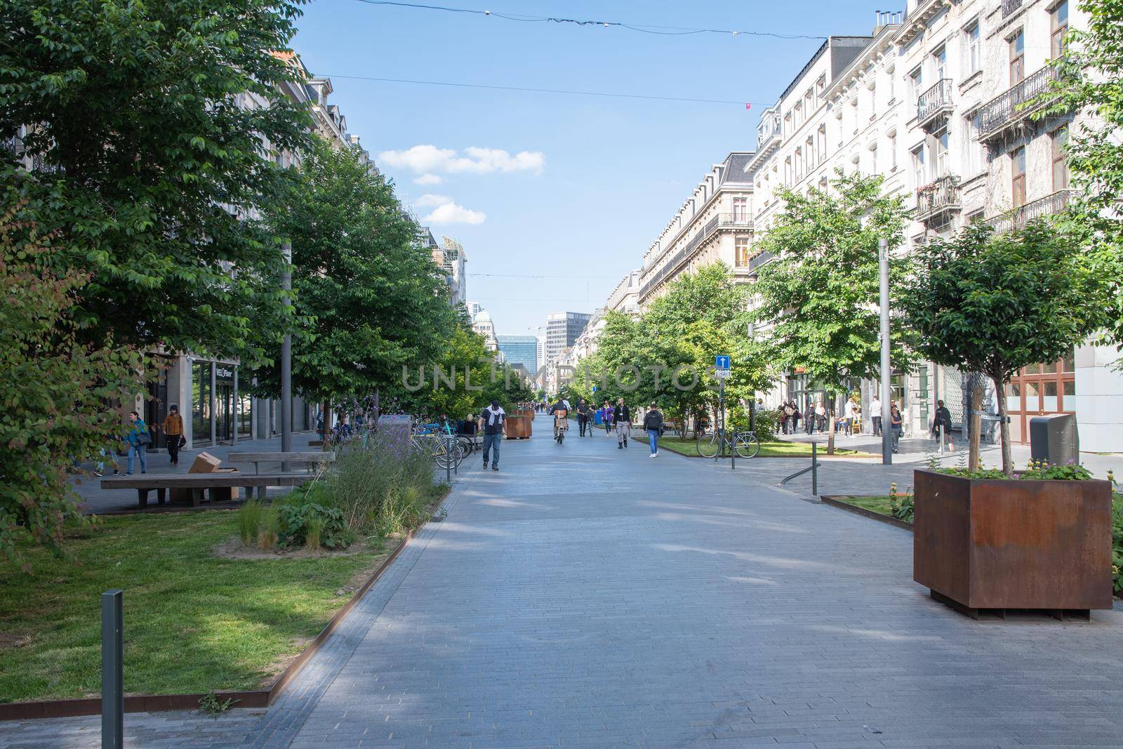 BRUSSELS, BELGIUM - June 02, 2022: a crowded 'Rue Antoine Dansaert shopping street in Brussels, Belgium during a summer day. High quality photo