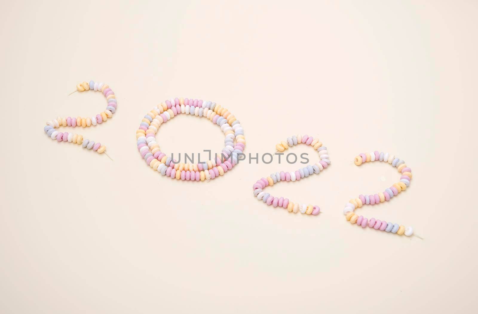 figures of the year 2022 lined with pastel colors candies lettering High quality photo