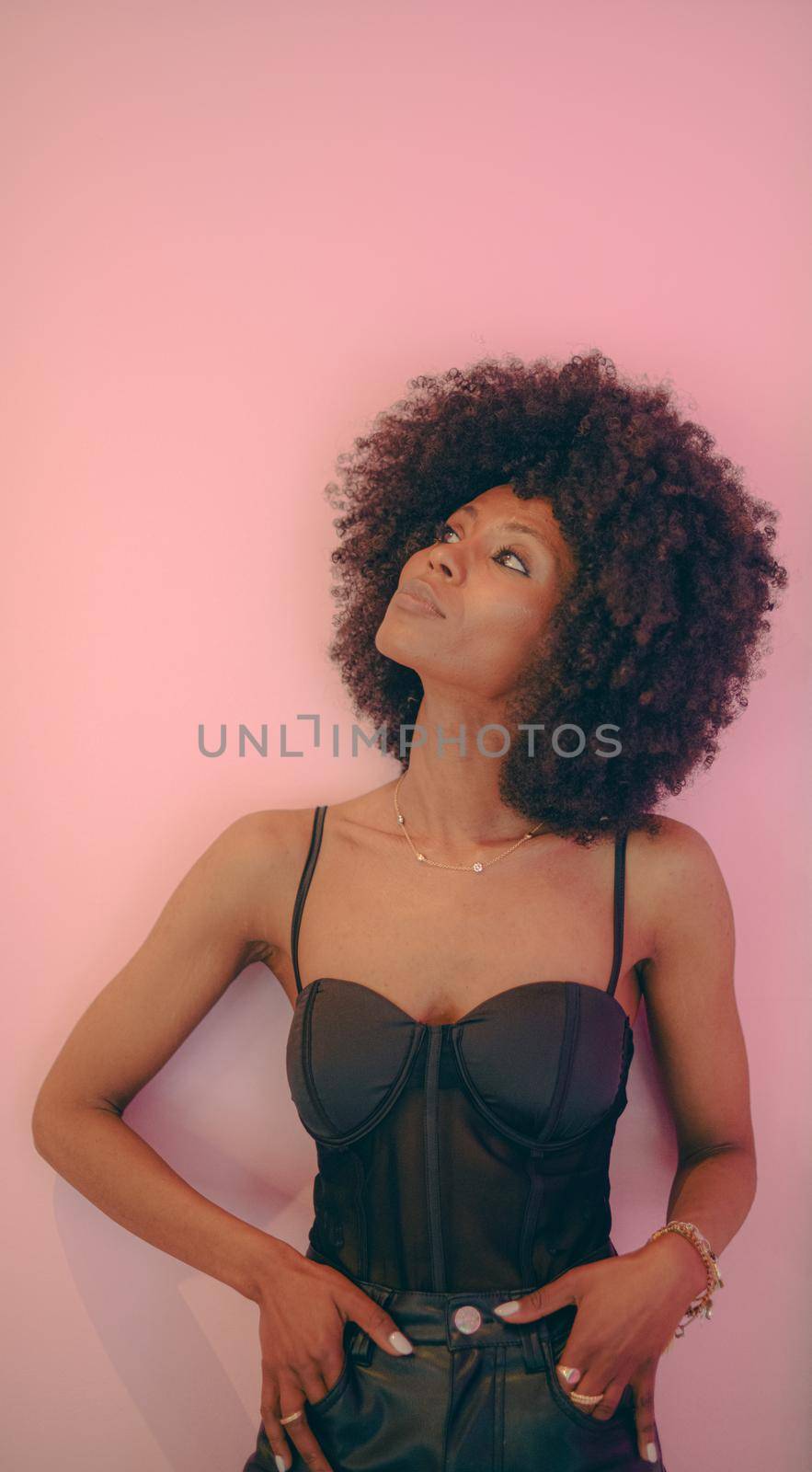 Young attractive African woman with happy cheerful smile having fun in studio