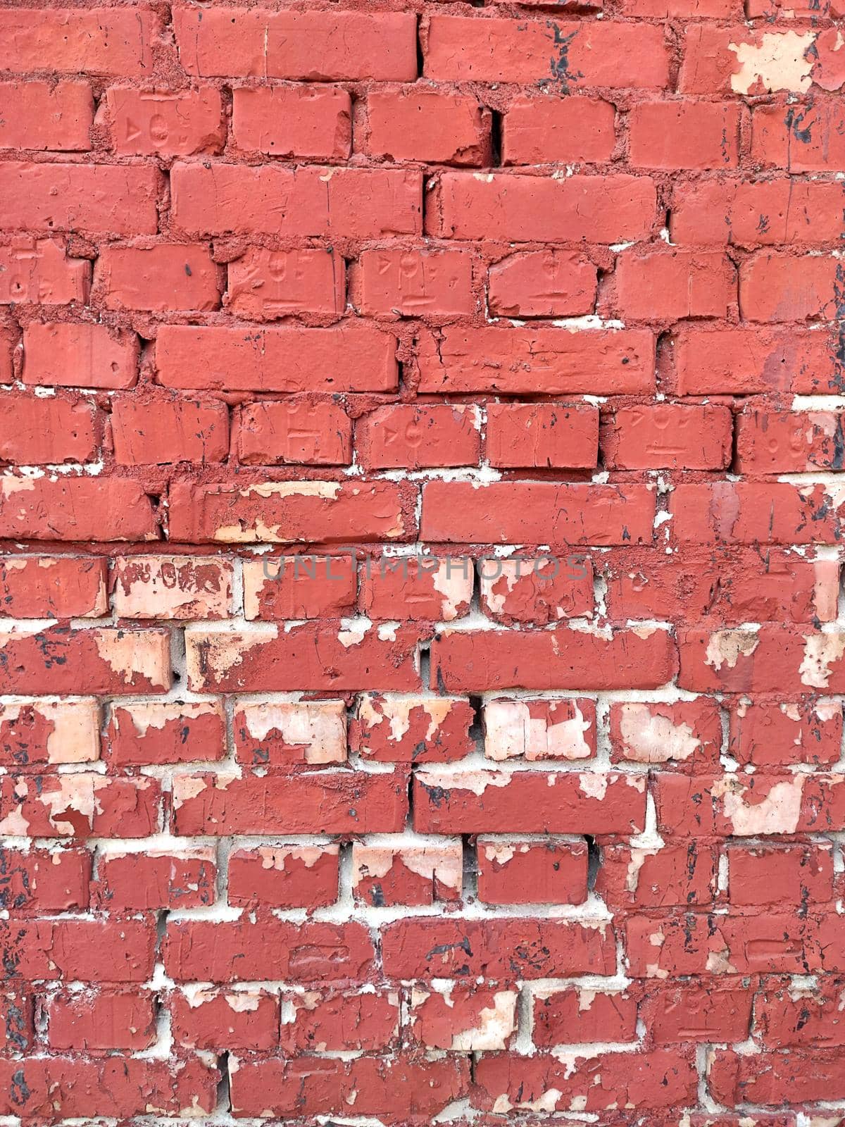 Colorful red brick wall on the house. Texture of red stone blocks, close up. Background. Old building.