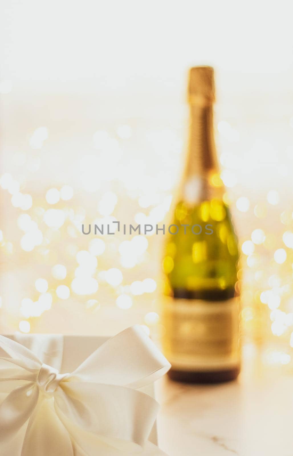 Romantic celebration, lifestyle and luxury present concept - The bottle of champagne and holiday gift box