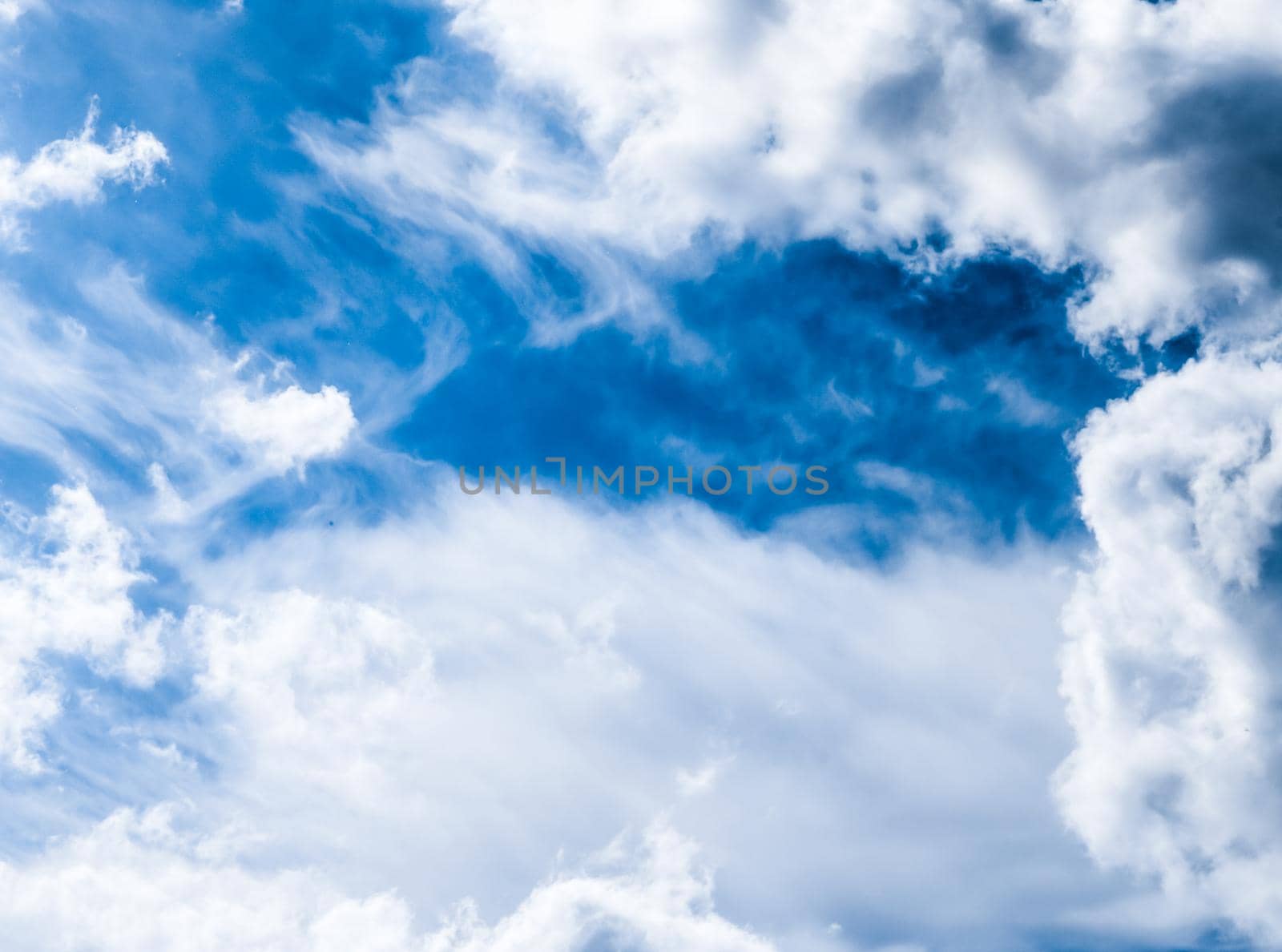 Nature backdrop, solar energy and spiritual concept - Blue sky background, white clouds and bright sunlight