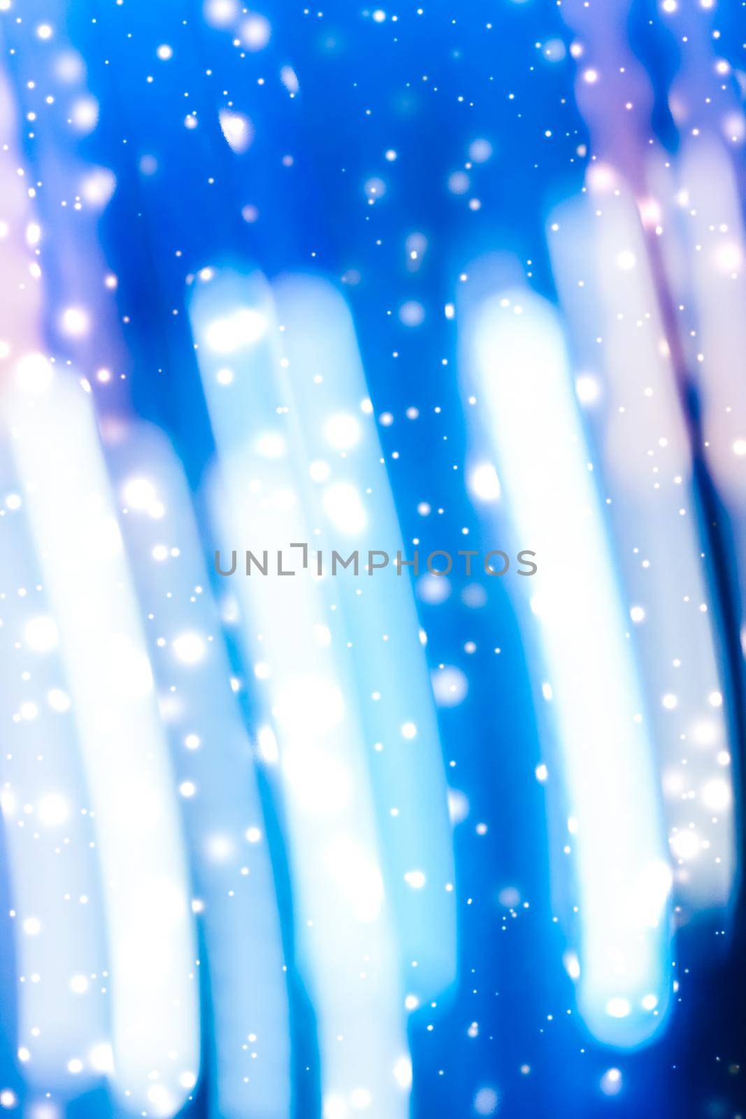 Christmas lights, New Years Eve card and cosmic texture concept - Winter holiday abstract background, glowing snow and magic sparkling shiny glitter