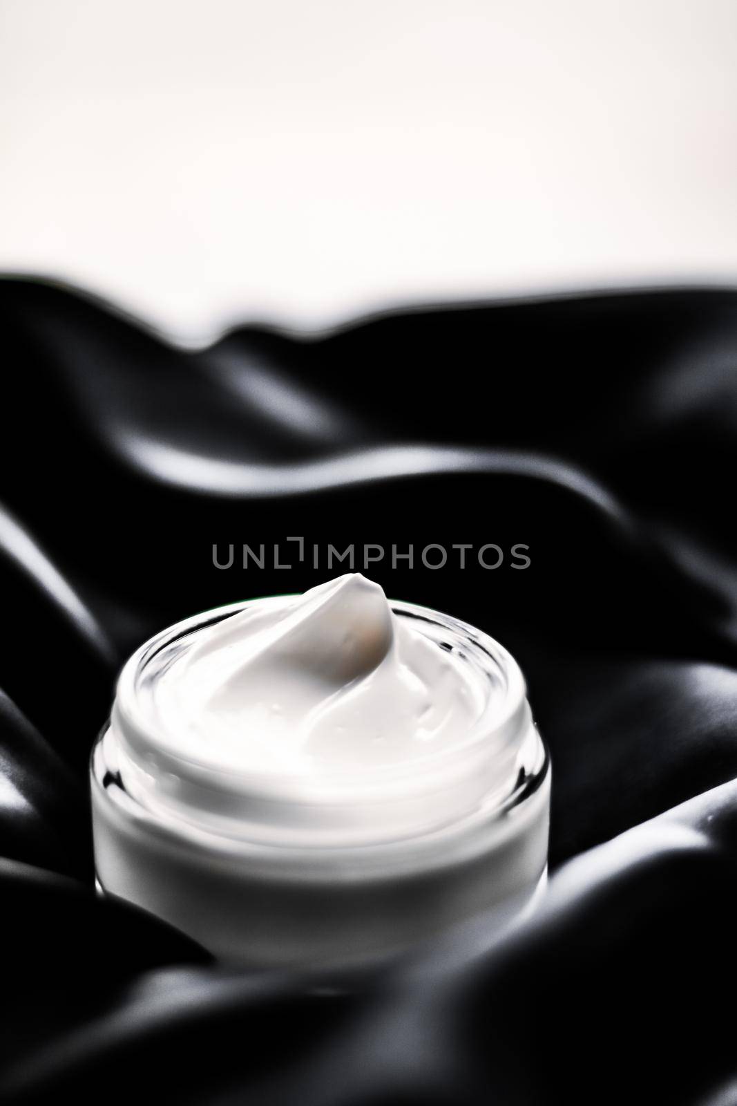 Luxury sensitive skincare moisturizing face cream on black silk background by Anneleven