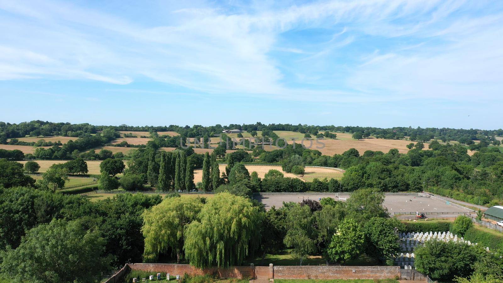 Aerial top down view from the drone onto the narrow passageway leading to a small chapel. Chapel located in a big green open area of fields near Rosary Manor, Mill Hill, North West London, London, UK.