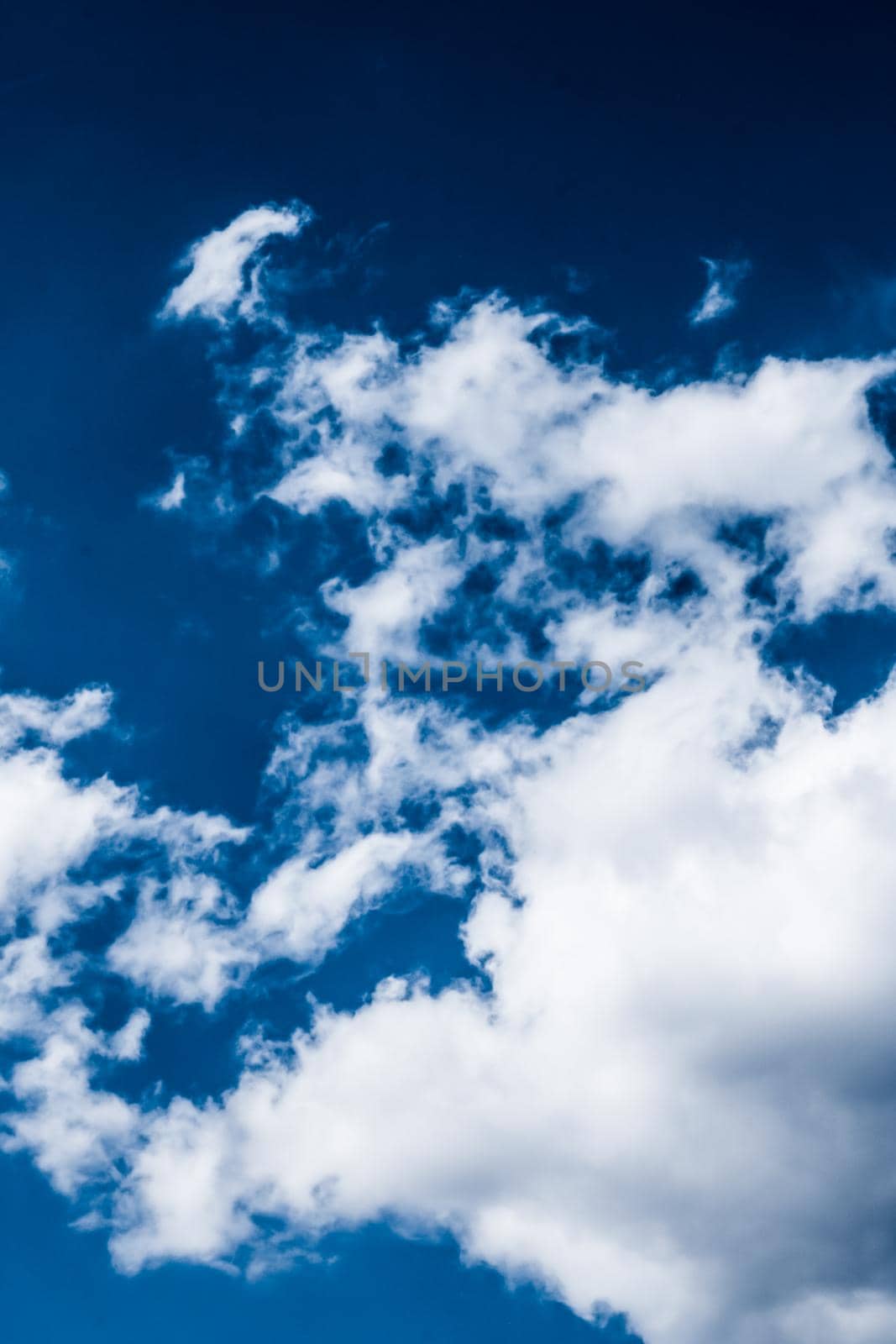 Nature backdrop, solar energy and spiritual concept - Blue sky background, white clouds and bright sunlight