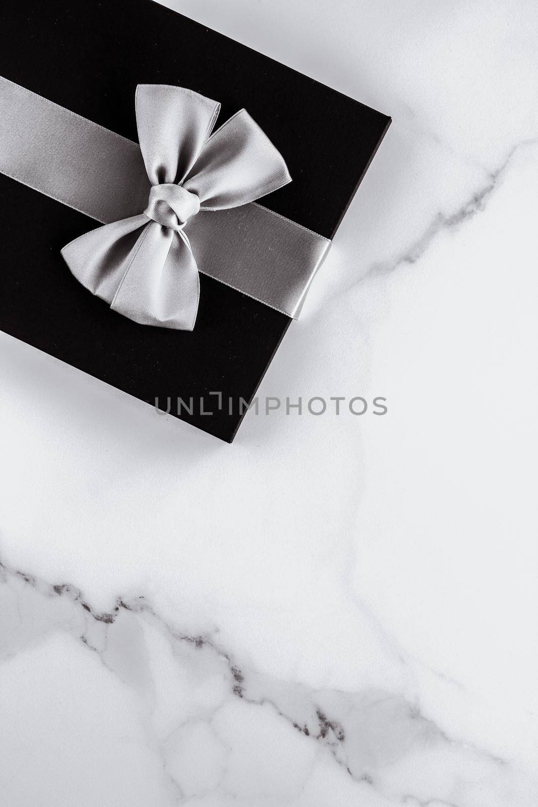 Present for him, shop sale promotion and anniversary celebration concept - Luxury holiday gifts with silver silk ribbon and bow on marble background