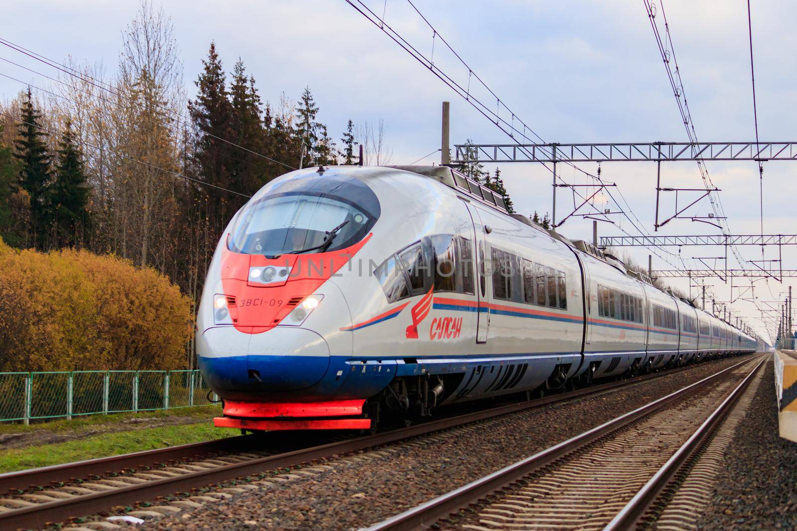 High - speed train sapsan in autumn . An article about high-speed trains. Lyuban, Russia, October 11, 2021 by alenka2194
