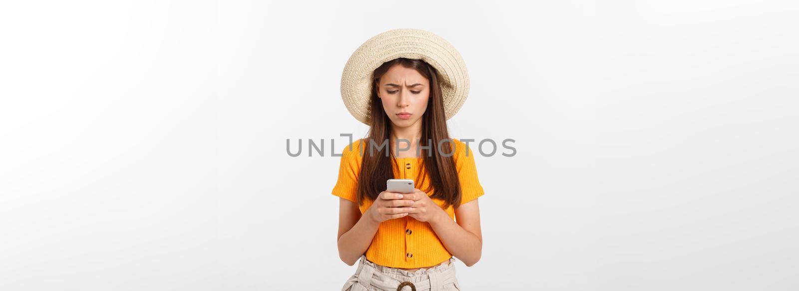 Profile portrait of good-looking attractive woman holding smartphone in hand and using it with serious face expression