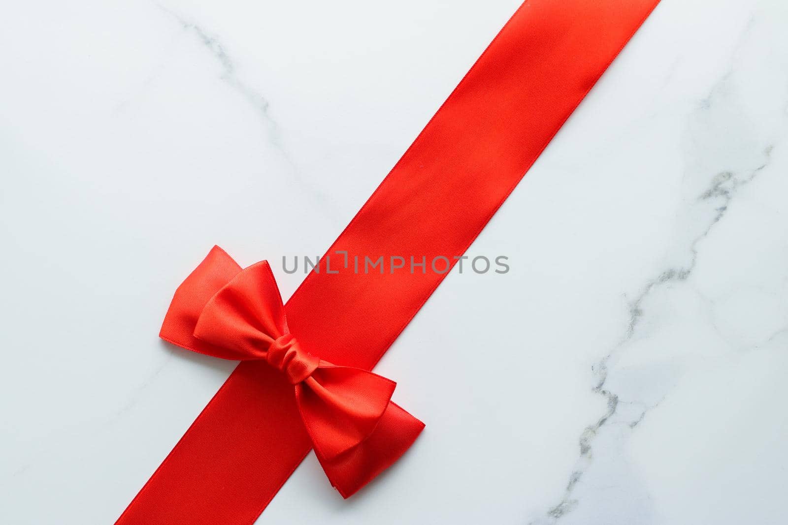 Holiday decor, feminine design and flatlay concept - Red silk ribbon on marble, top view